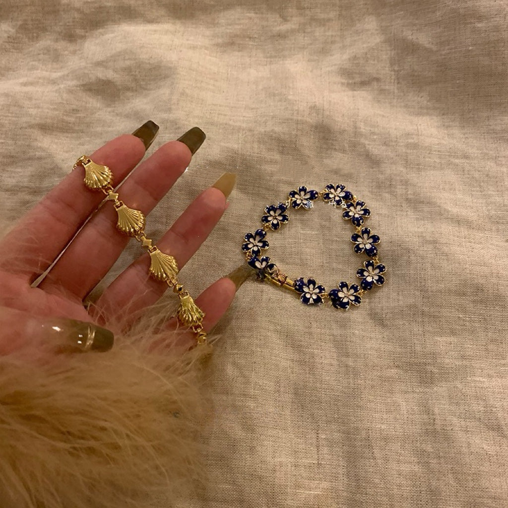 Just Lil Things Artificial Golden Seashell and Enamel Daisy Flower Bracelet jltb0523